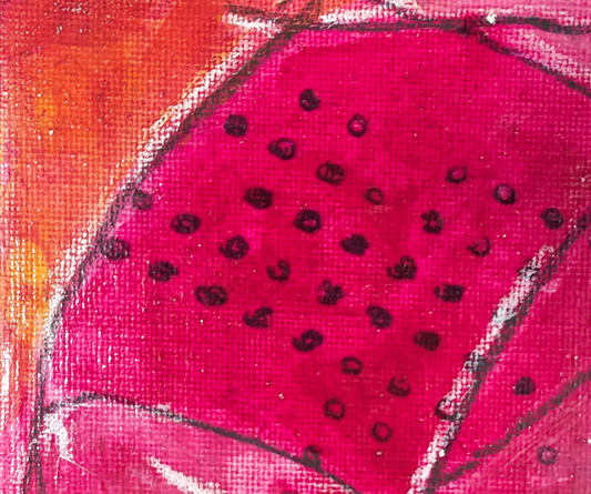 apparently this is “Close-up of a pink dragon fruit with black seeds on a textured surface.”