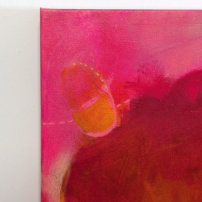 detail, tabla beet science by helen carter. Abstract painting featuring a large central dark red and brown organic shape with bright pink, orange, and yellow areas around it.