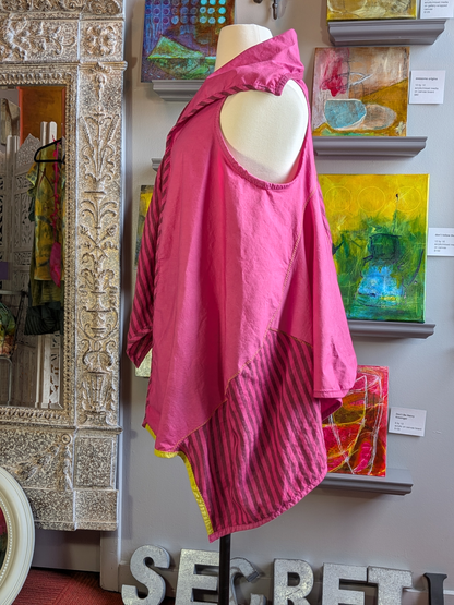 Mannequin wearing a pink garment with abstract art in the background
