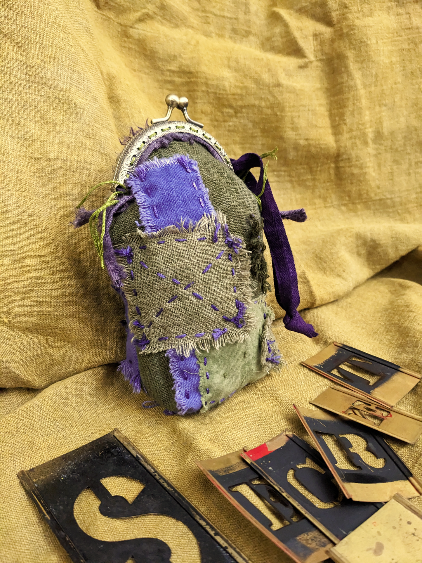 purple and olive green artifacted coin purse